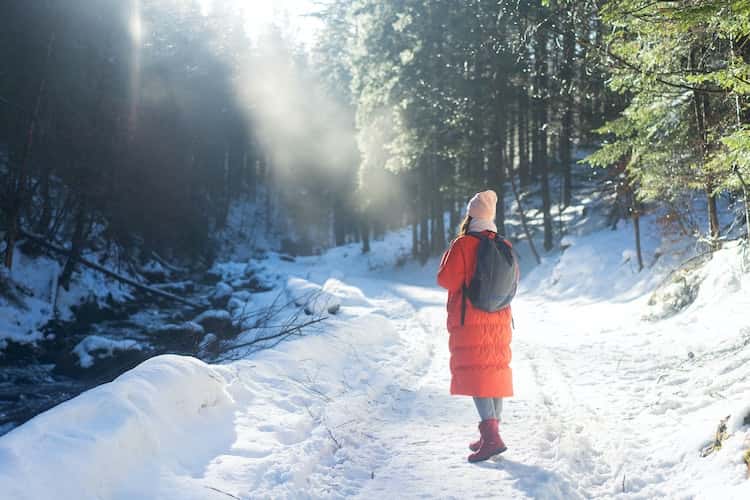depressed woman hiking in snow